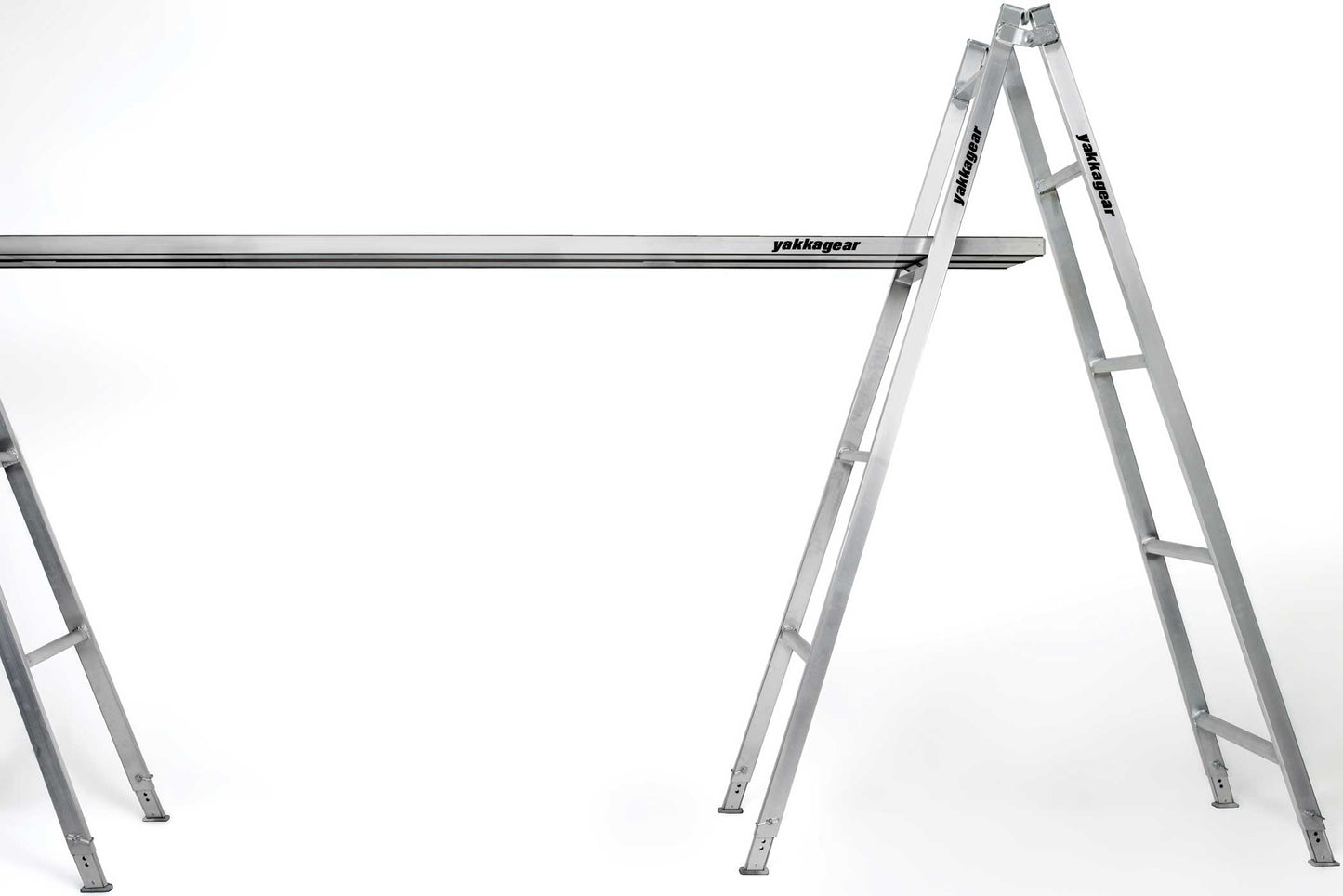 Yakka Gear Australia Aluminium Trestles as access equipment or painters A-frame ladders. Various sized trestles available including 1.8m, 2.4m, 3.0m, 3.6m, and 4.2m. All the trestles are adjustable by 30cm. View from the side being used with planks across two trestles.