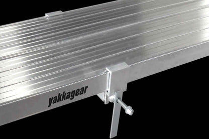 Yakka Gear Australia Melbourne Made Sustainable Aluminium Planks as access equipment. Various sized planks available including 2.5m, 3m, 3.6m, 4m, 5m and 6m planks. Two planks being shown clamped together for more stability and reduce flex. Can also be used as access equipment on scaffolding or trestles, as hungry boards, ramps, saw horse, plastering stool, steps for stairs, side steps to a 4WD vehicle or boat trailer. 